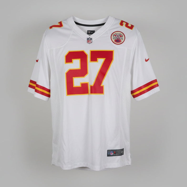 White sports jersey with red and yellow numbers hanging on a door