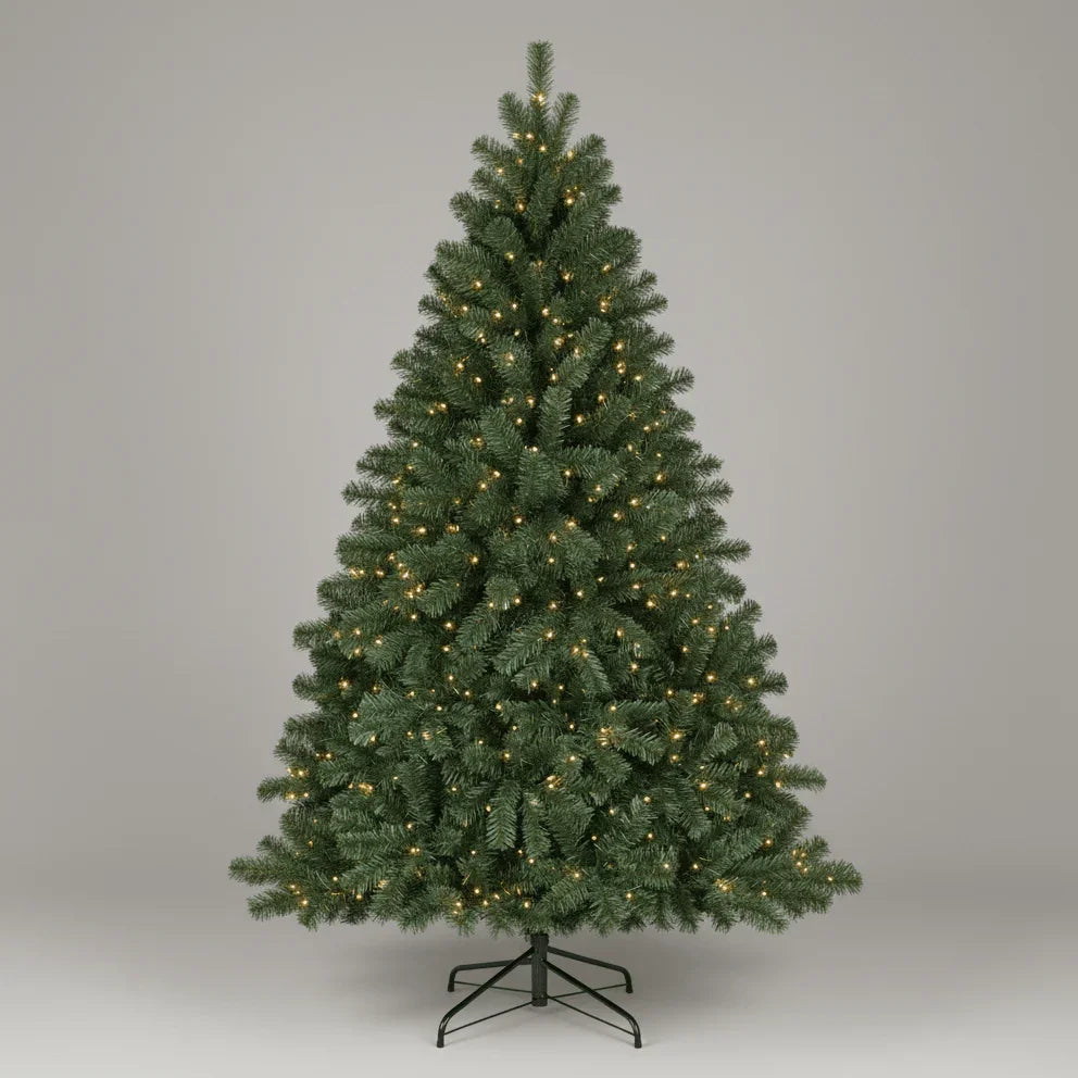 Green artificial Christmas tree with lights on a white background