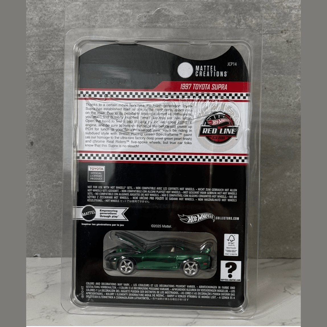 Toy car in packaging with Mattel and Hot Wheels branding on a gray background