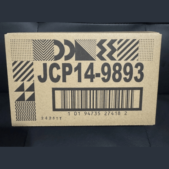 Cardboard box with geometric patterns and a barcode on a dark background