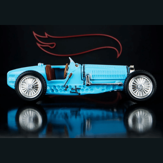 Blue vintage-style toy car with a reflective surface and dark background