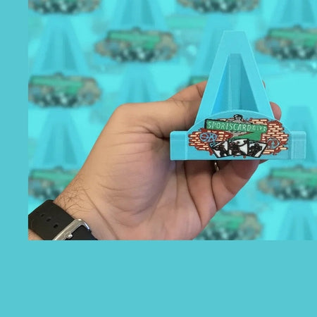 Hand holding a blue triangular card with a logo against a blurred background of similar cards.