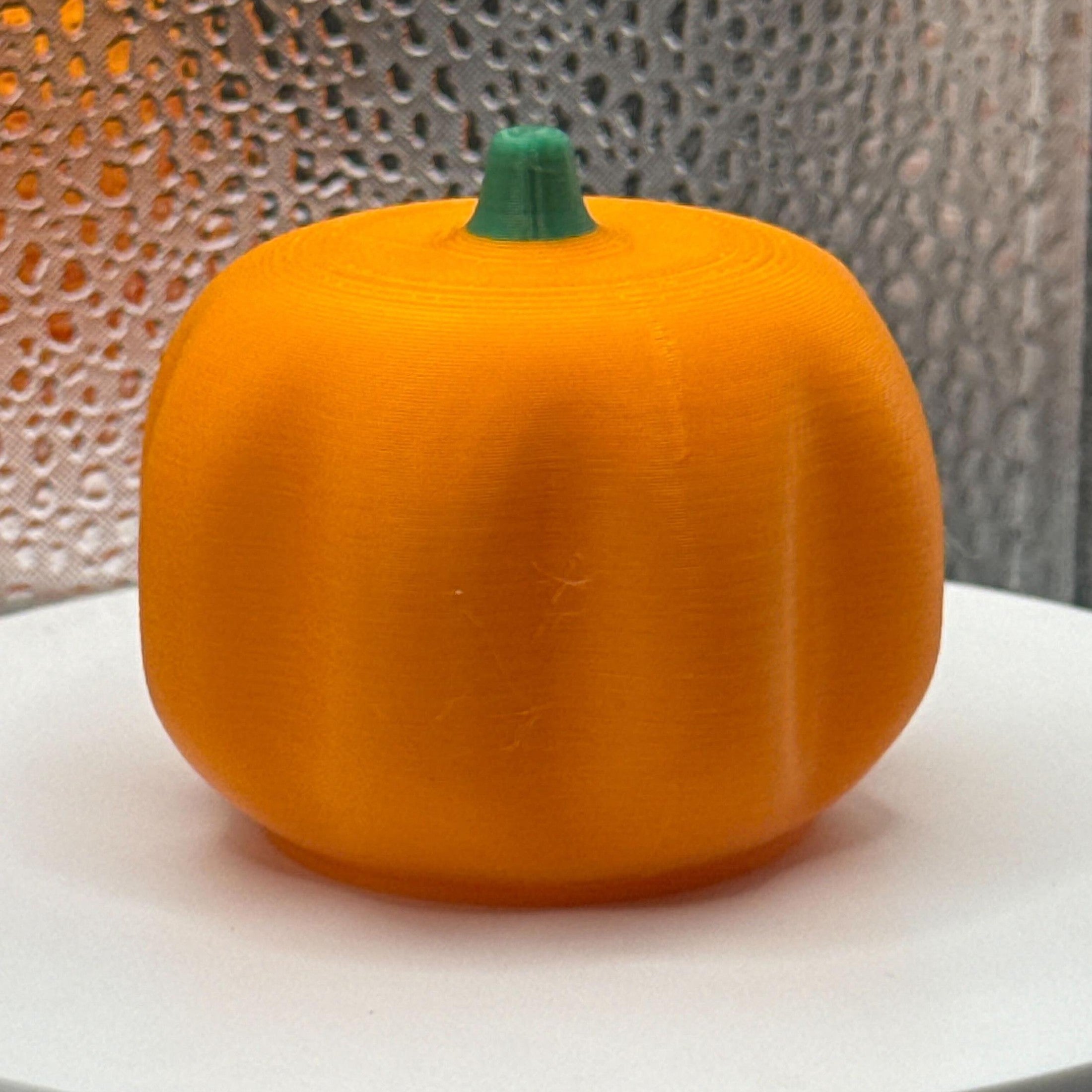 3D Printed Tealight Jack-O-Lantern With Green Stem.