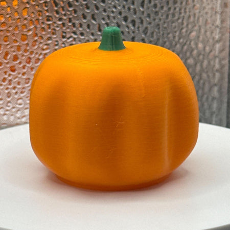 3D Printed Tealight Jack-O-Lantern With Green Stem.