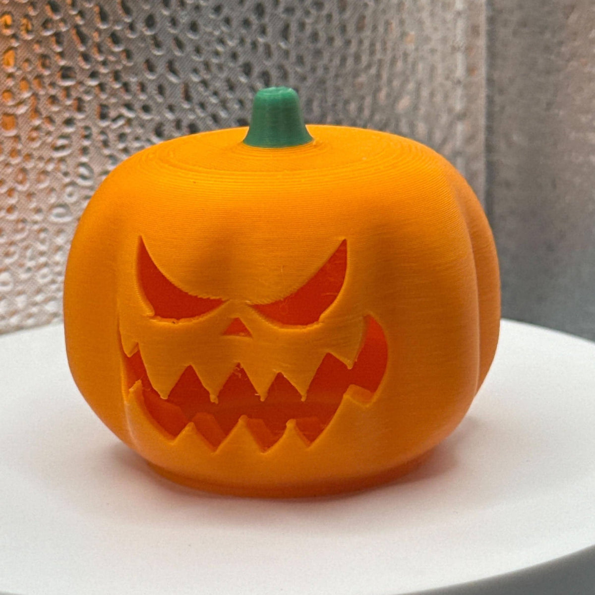 3D Printed Tealight Jack-O-Lantern With Green Stem.