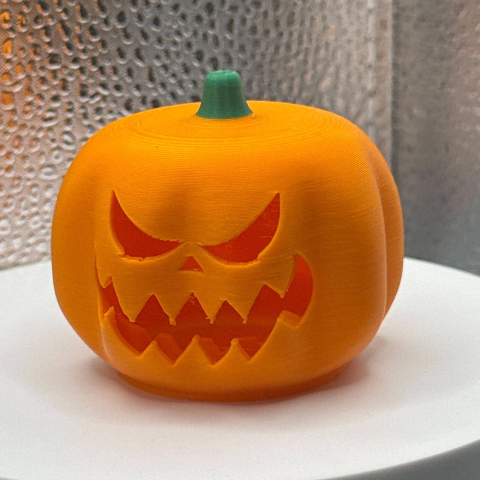 3D Printed Tealight Jack-O-Lantern With Green Stem.