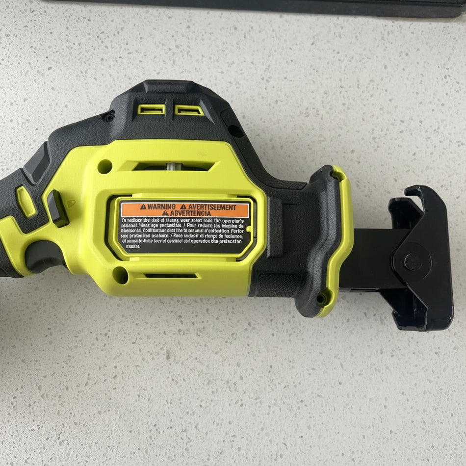Yellow and black power tool on a light gray surface