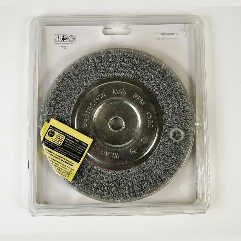 Wire wheel brush with protective cover and warning label on a white background