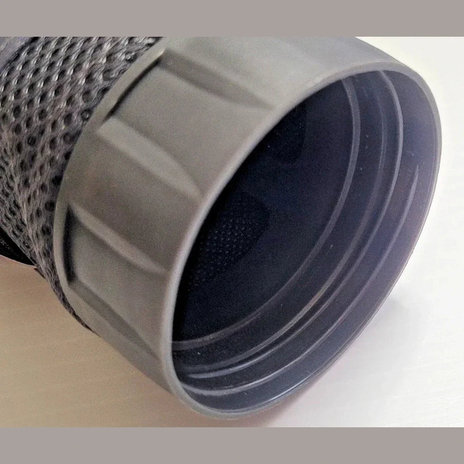 Close-up of a gray cylindrical object with textured surface on a white background