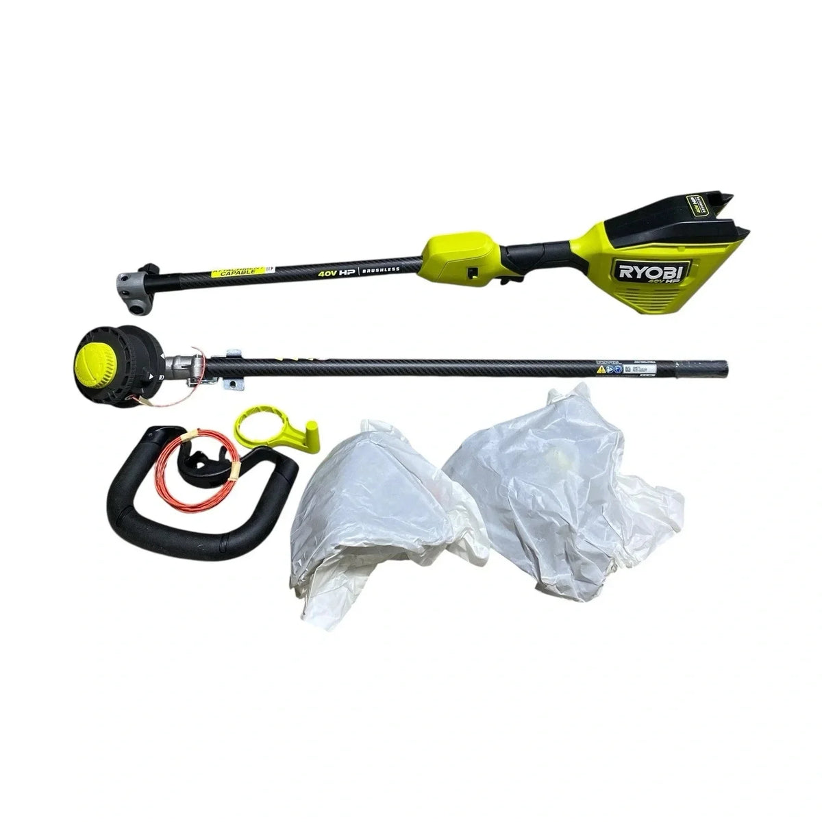 Ryobi pole pruner set with attachments on a white background