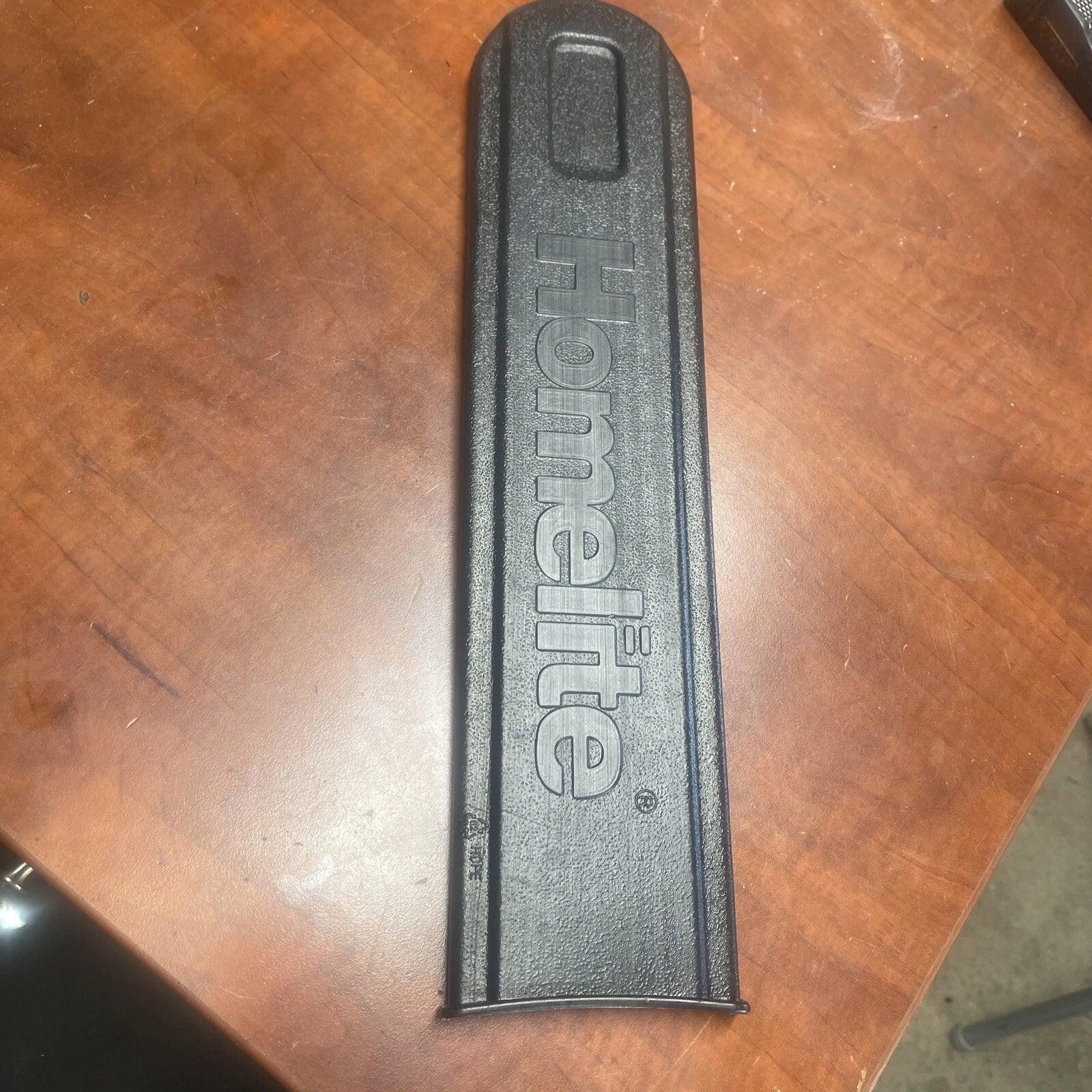 Black tool handle with 'Home Lite' branding on a wooden surface