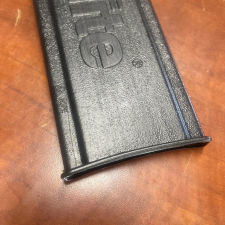 Black gun magazine on a wooden surface