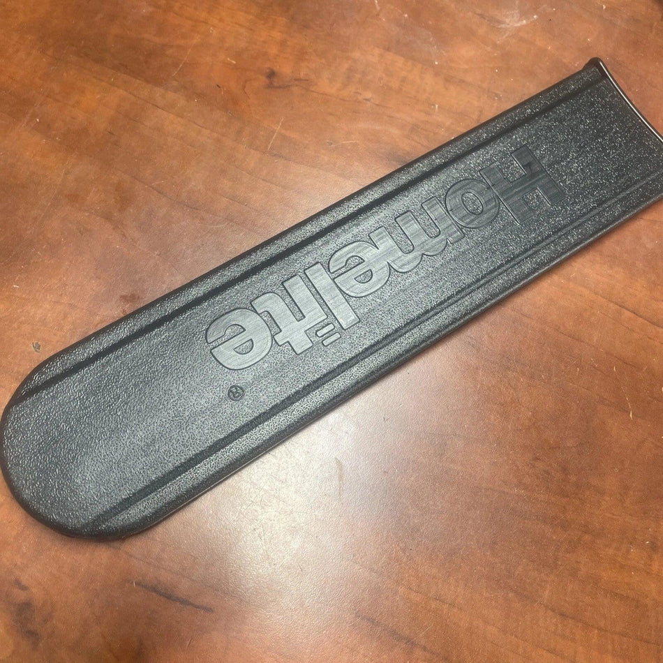Black strap with 'Homeite' branding on a wooden surface