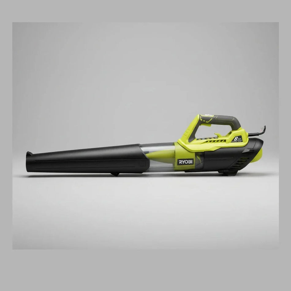 Ryobi leaf blower on a concrete floor with a gray curtain in the background