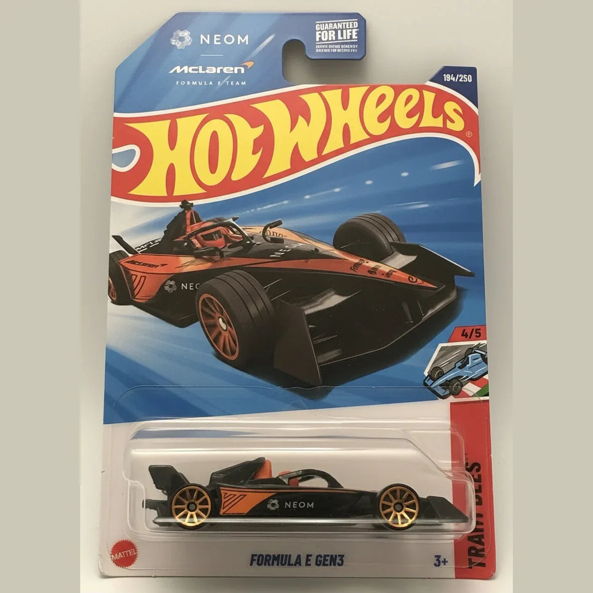 Hot Wheels McLaren Formula E car in packaging on a brown background