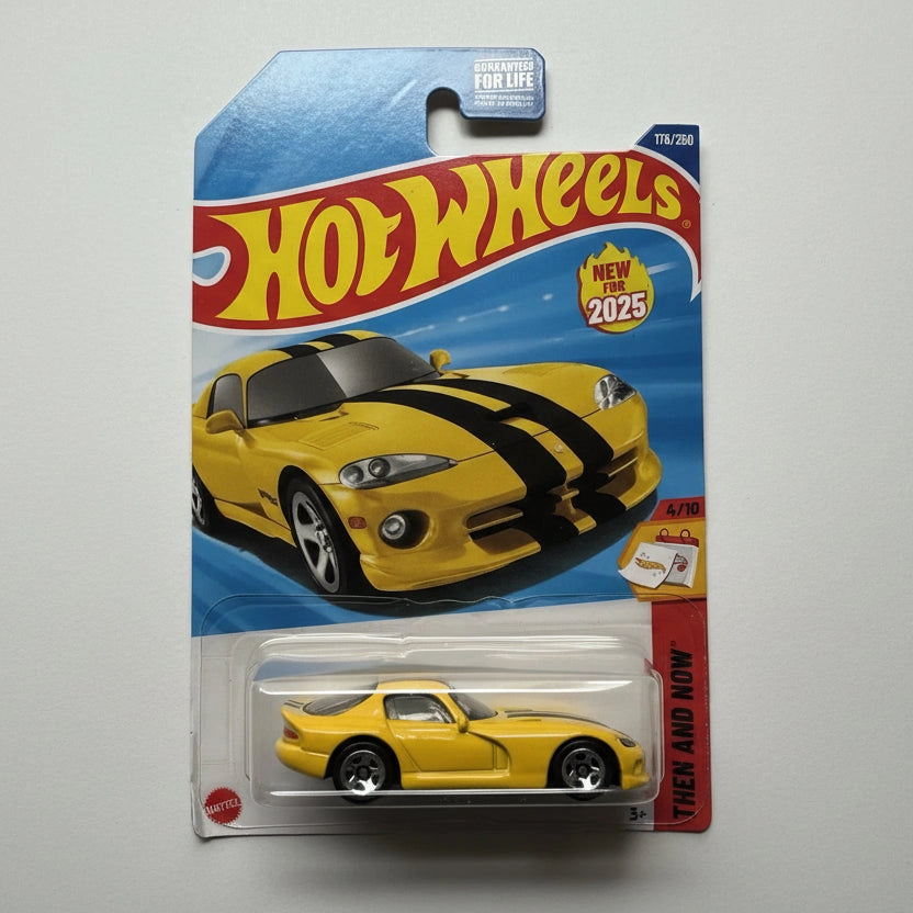 Hot Wheels toy car in packaging with a yellow and black striped car design.