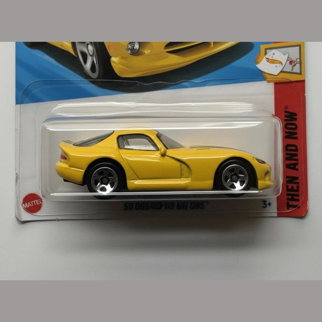 Yellow toy car in packaging with a visible Mattel logo.
