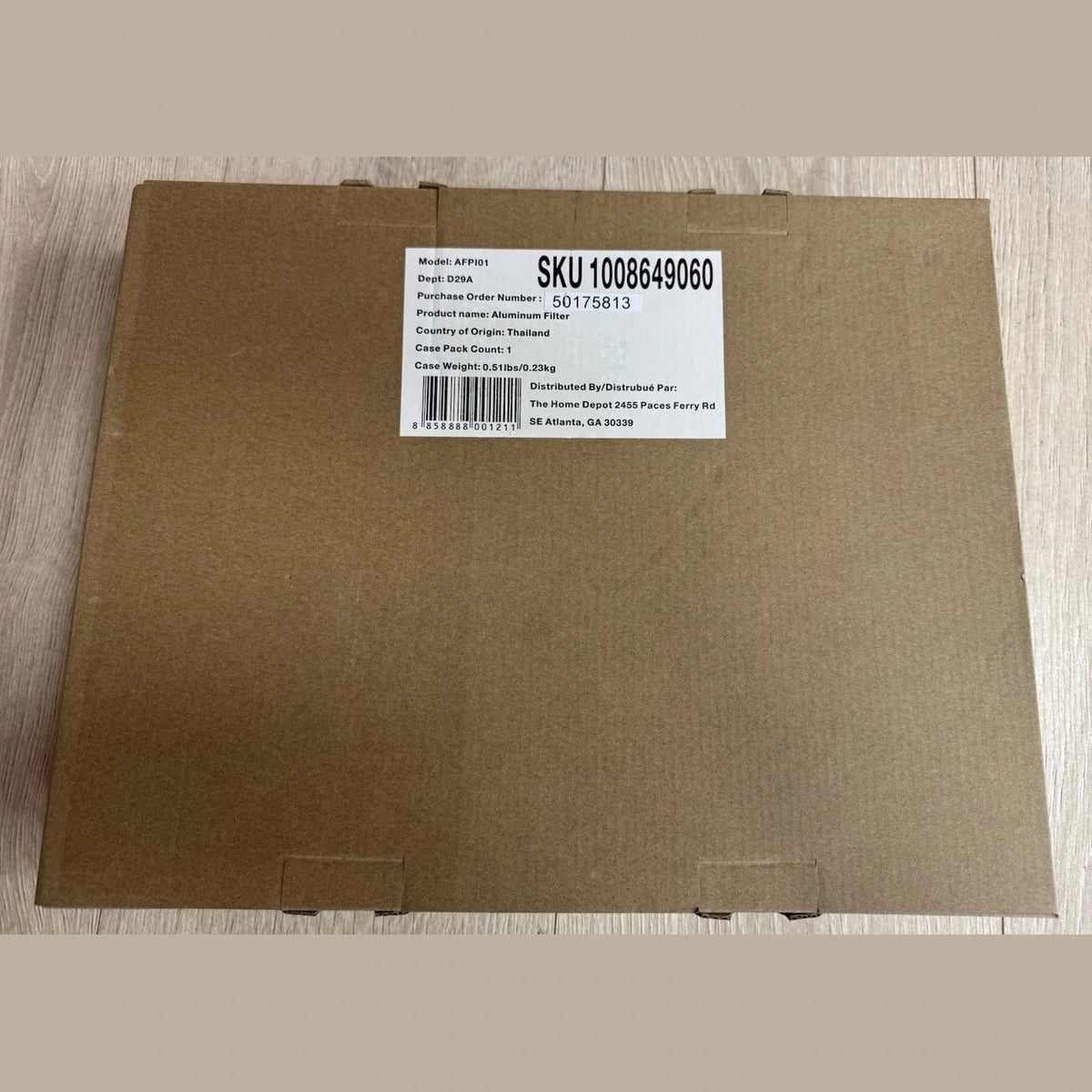 Brown cardboard box with a label on a wooden surface