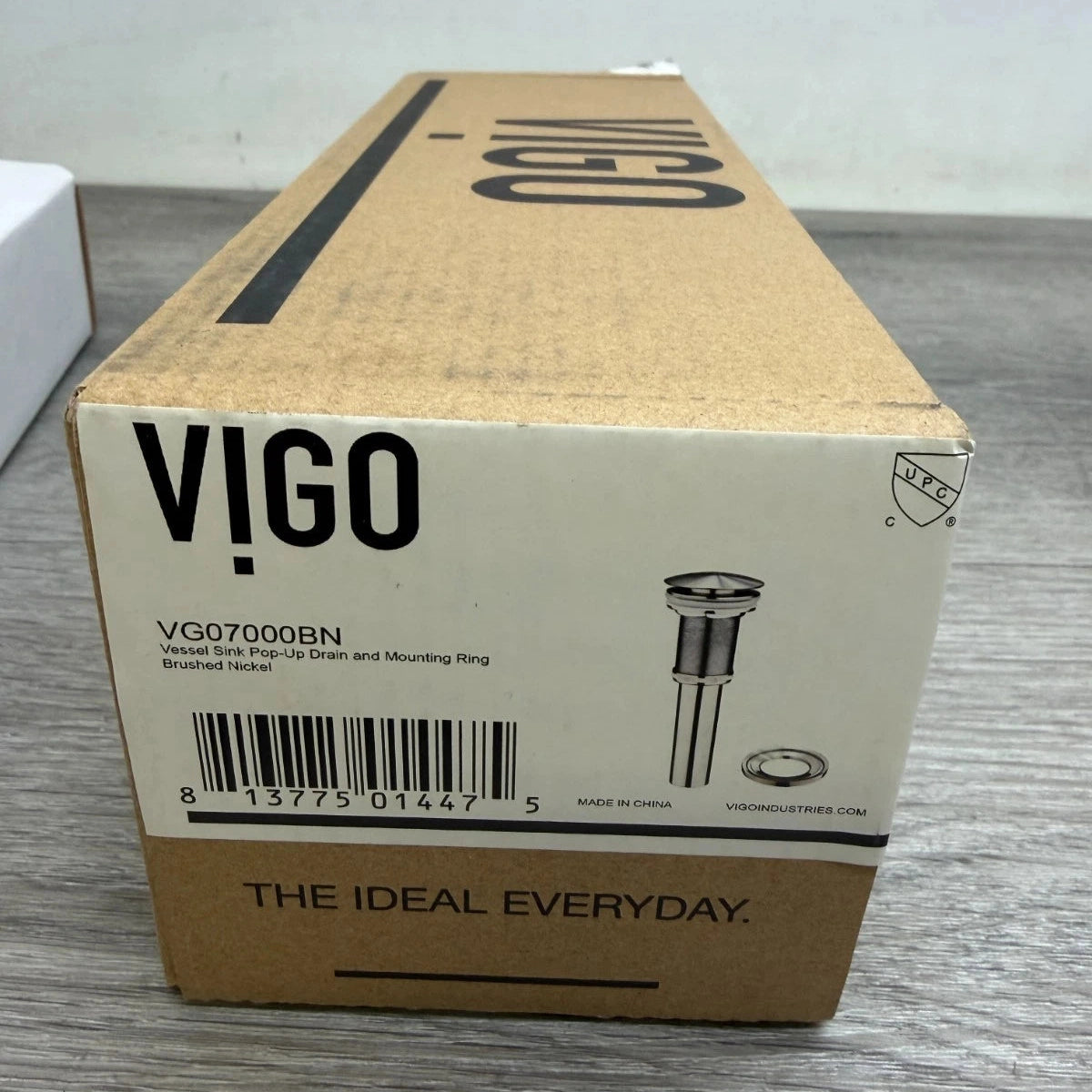 Cardboard box with VIGO branding on a gray surface