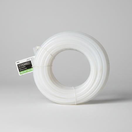 White spool of thread with a visible brand label on a woven surface
