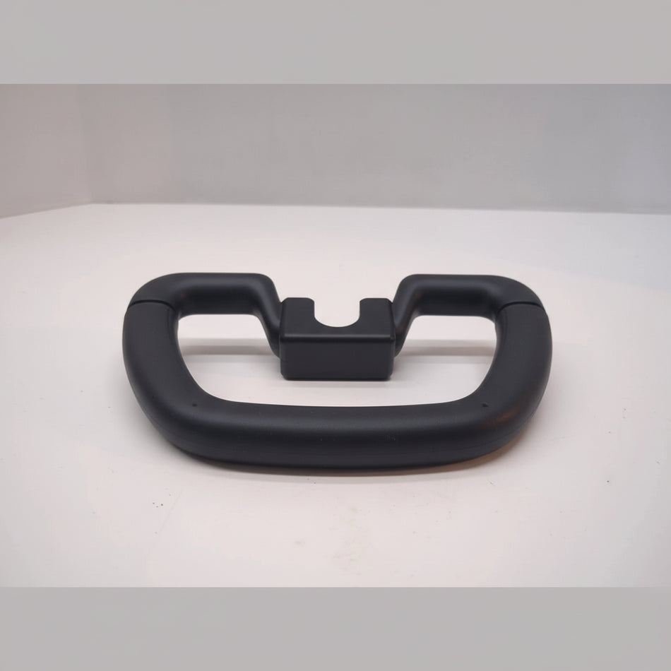 Black handle on a white surface with plastic wrap underneath