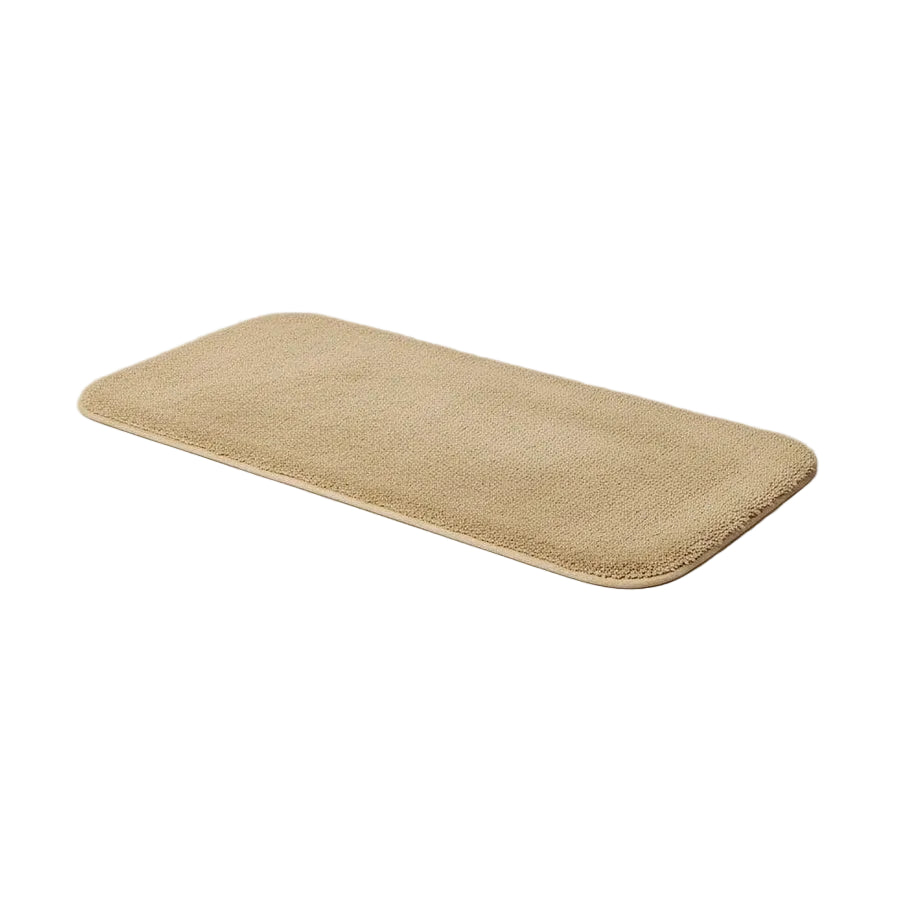 Beige bath mat on a light gray background