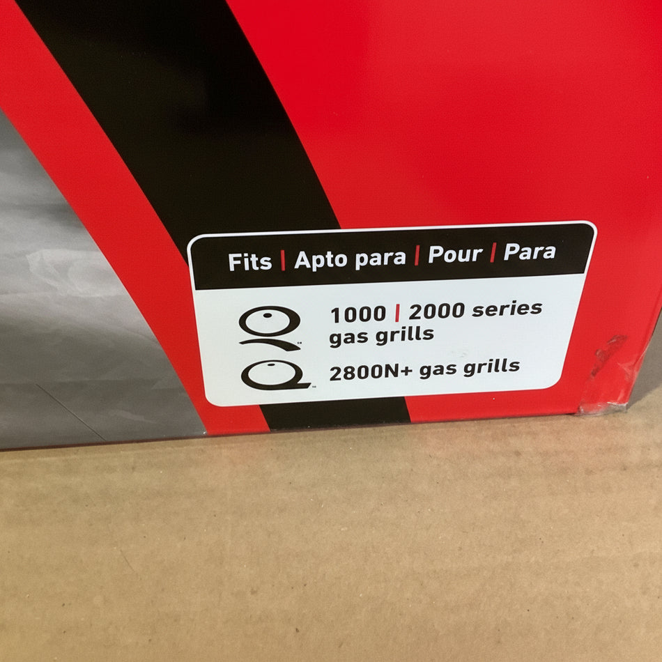 Red box with a label indicating compatibility for gas grills on a cardboard surface.