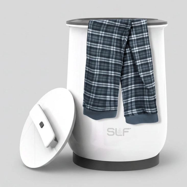White appliance with plaid pants on top, labeled 'multi-purpose heating', in a bathroom setting.