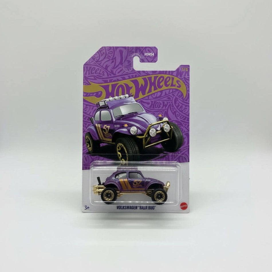 Hot Wheels toy car in purple and gold packaging on a gray carpet background