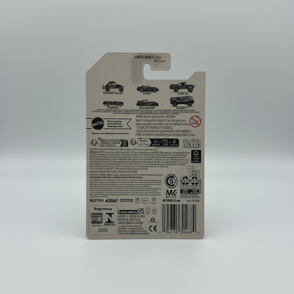 Back of a Hot Wheels toy packaging with branding and product information on a textured gray surface.