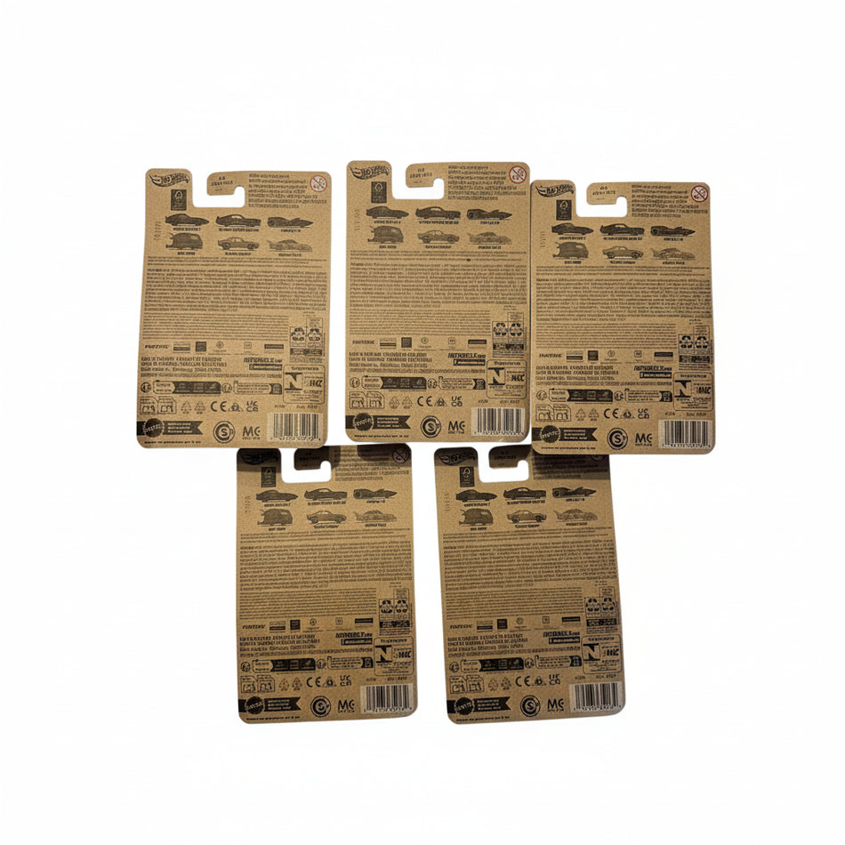 Four cardboard toy car packaging backs on a light surface