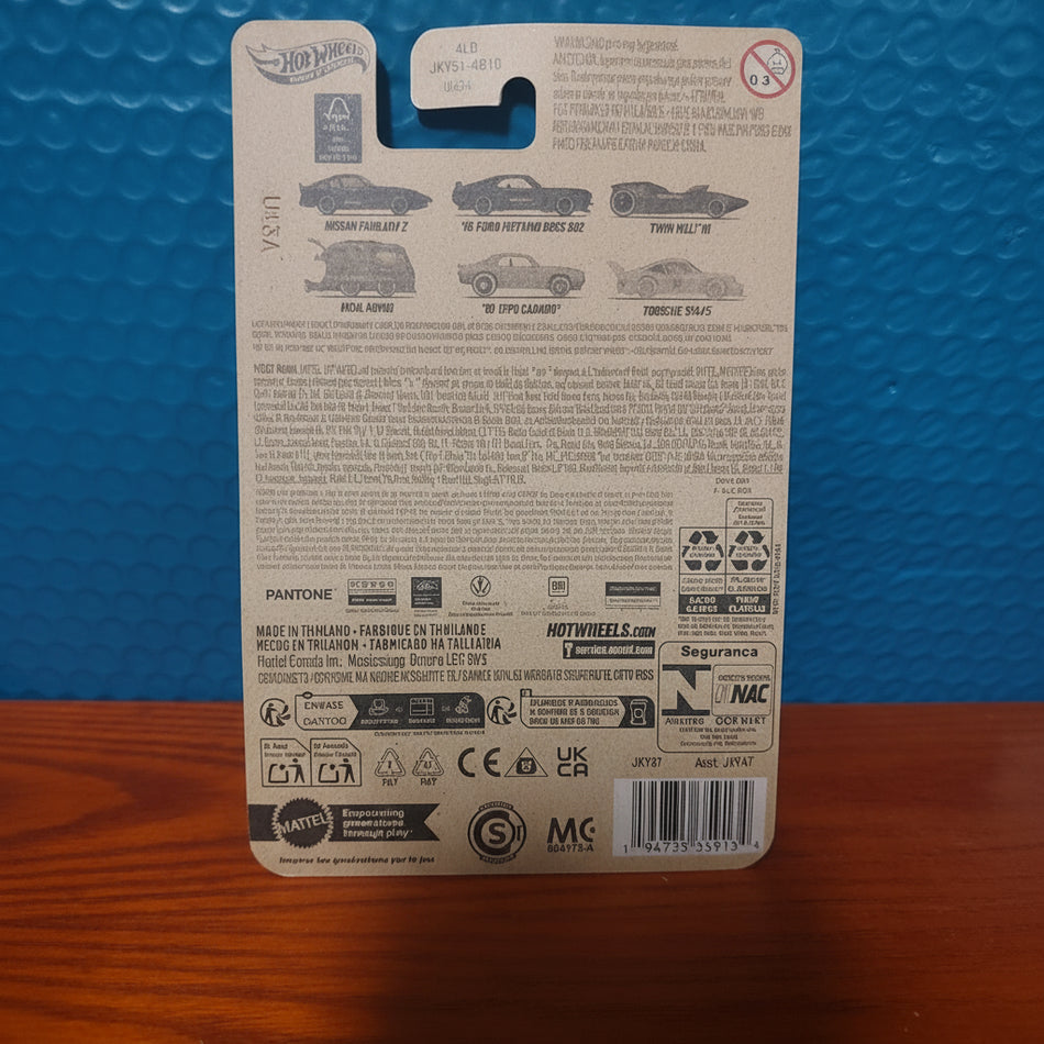 Back of a toy car packaging with text and logos on a blue and brown surface
