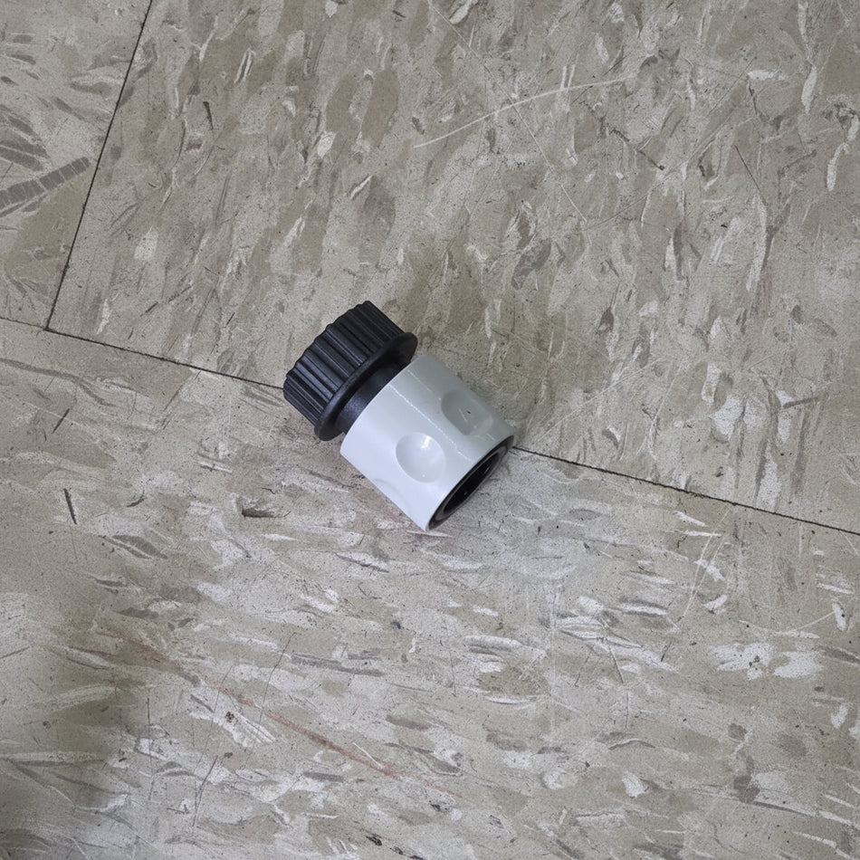 Plumbing fitting on a textured floor