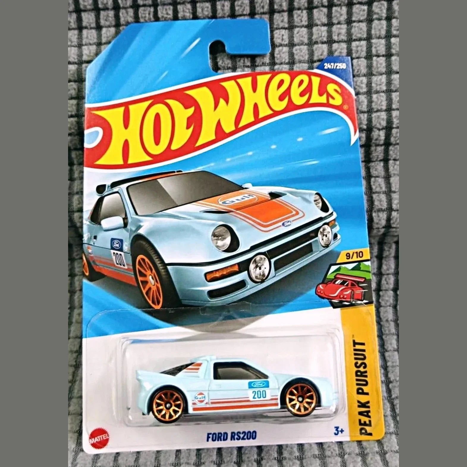 Hot Wheels Ford RS200 toy car in packaging on a checkered background