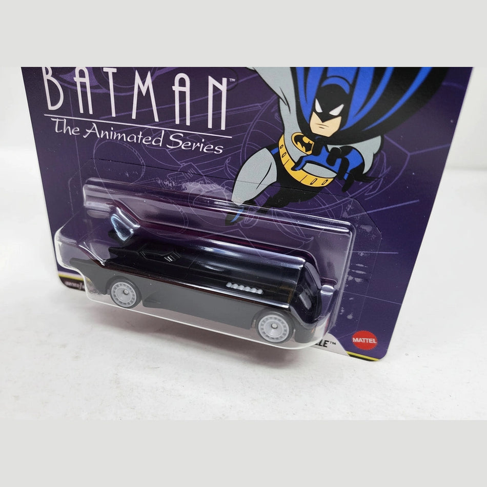 Toy car in clear packaging with Batman graphic on purple background