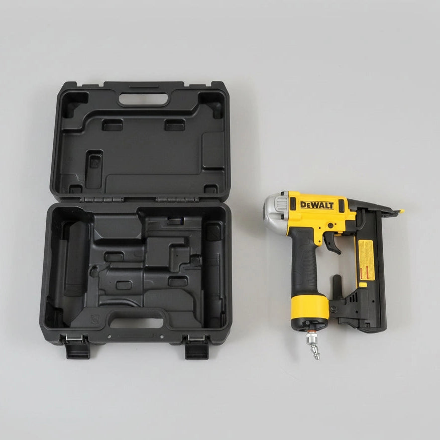 DeWalt nail gun with open black carrying case on a wooden floor.