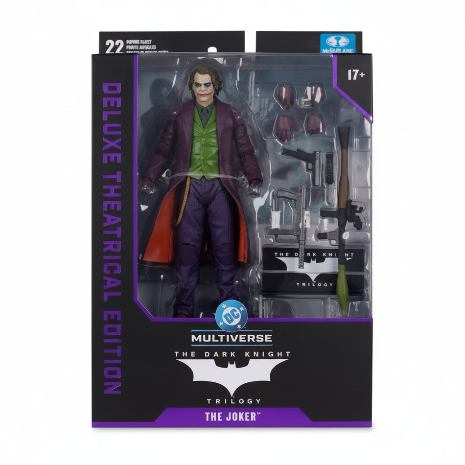 Action figure of The Joker from 'The Dark Knight' trilogy in packaging with visible branding.